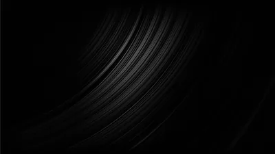 Long brushed streaks arc up from the lower left like grain on spun metal, thinning out until the right half is plain black.
