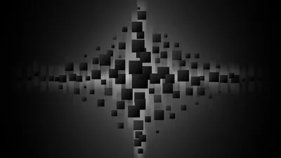 Grey and black cubes cluster into a diamond at the centre and scatter apart toward the edges, set on a softly lit dark grey wall.