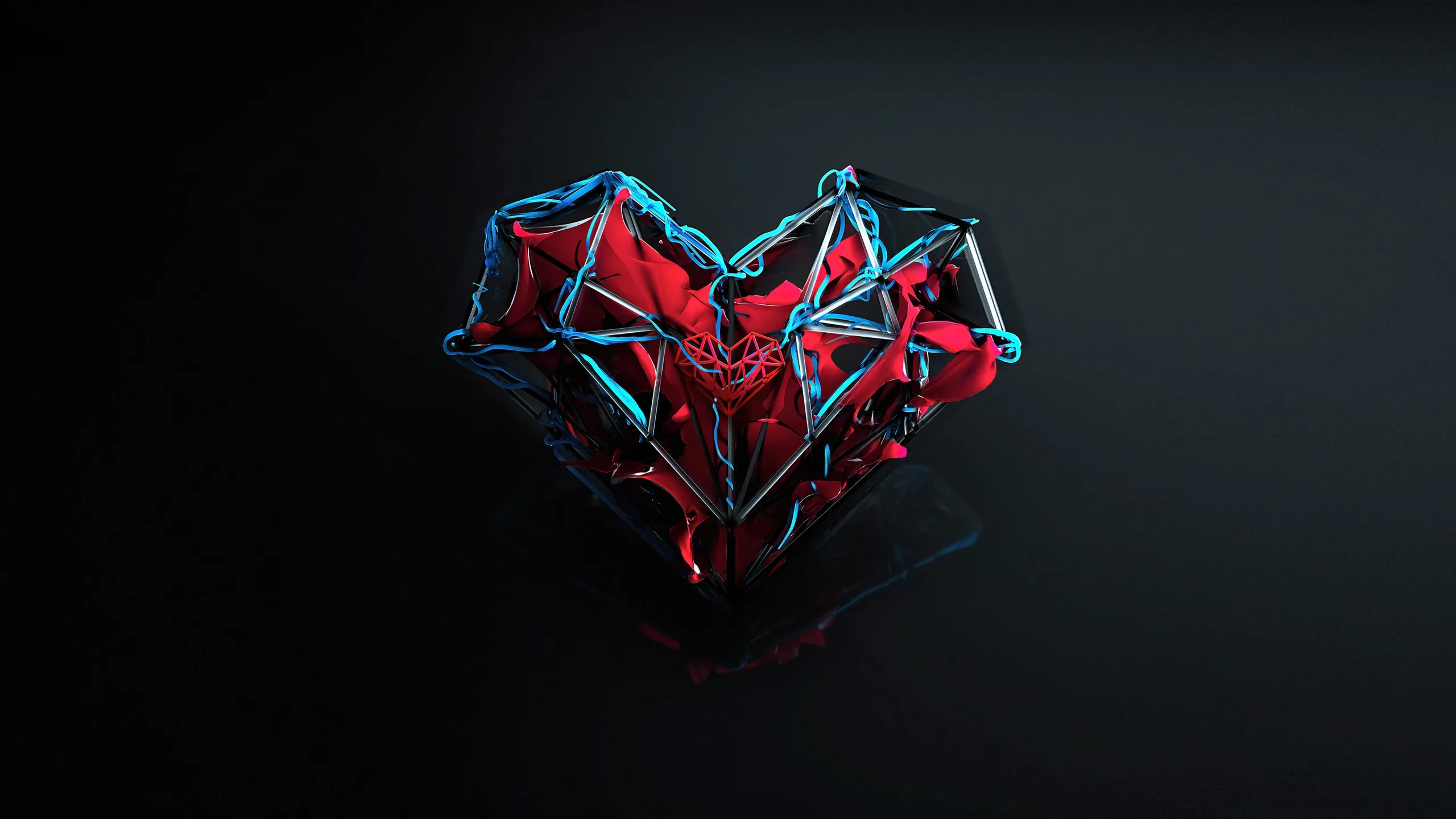 A faceted heart of red and blue metal panels breaks apart mid-air over a dark grey studio floor, its glow caught in the reflection below.