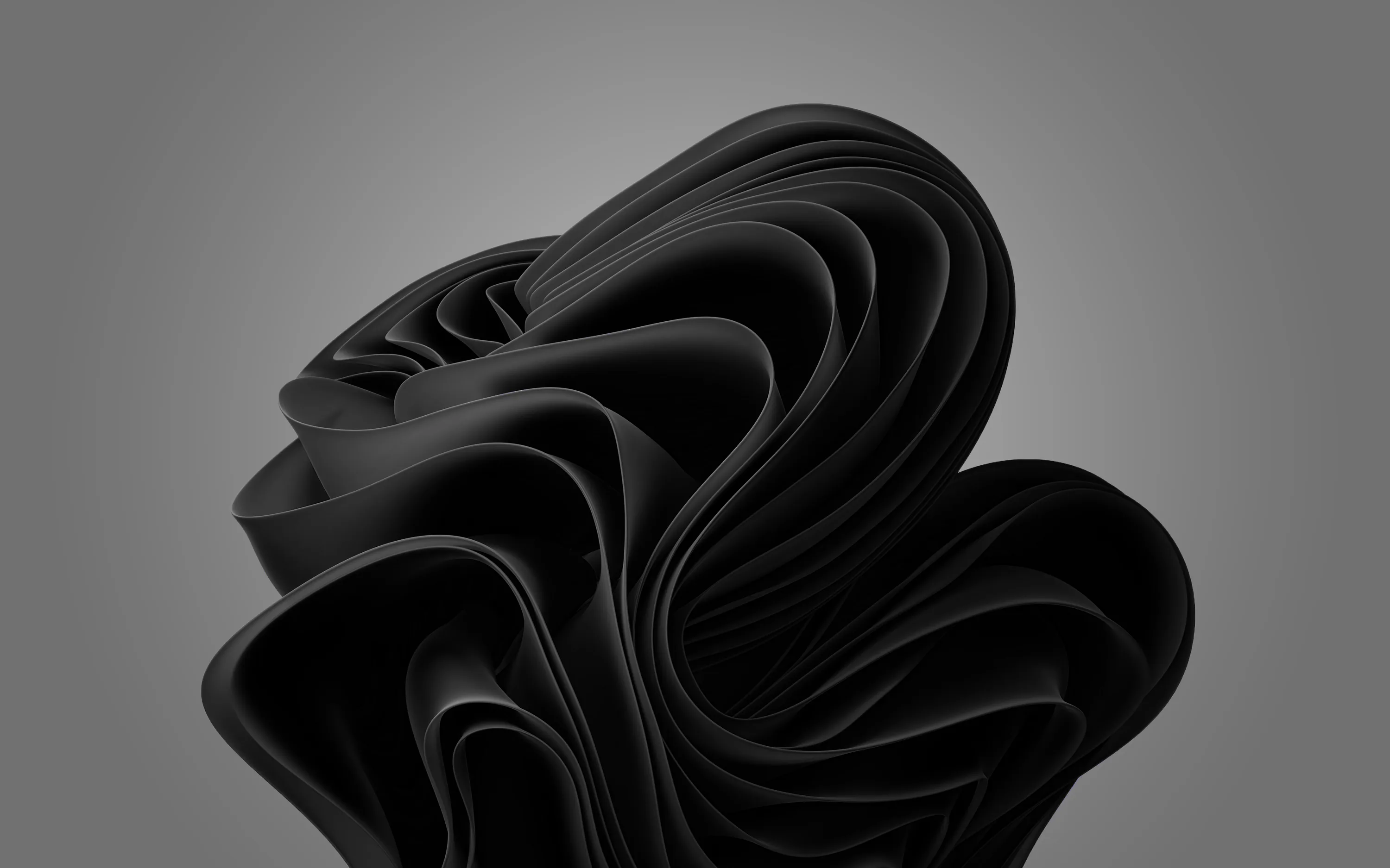 Layered sheets of black material twist into a knot at the centre of a plain grey background, each fold separated only by a thin line of light.