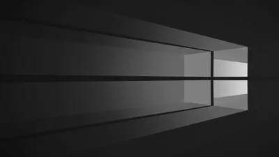 The four-pane window mark rendered in soft grey light on a dark charcoal field, light falling in from the right edge.