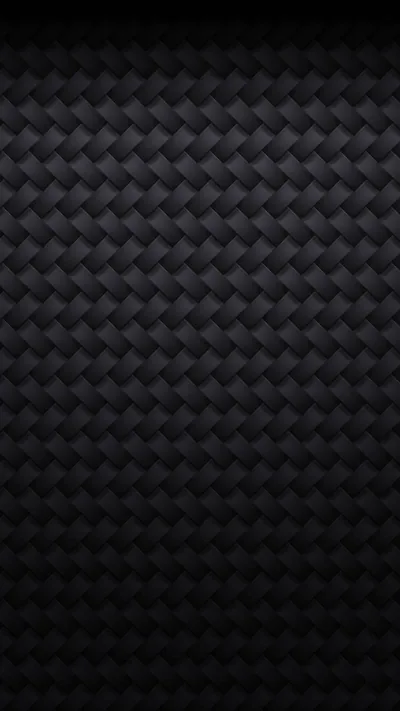A tight basket weave of small charcoal squares repeats across the frame, each tile catching a slightly different angle of light.