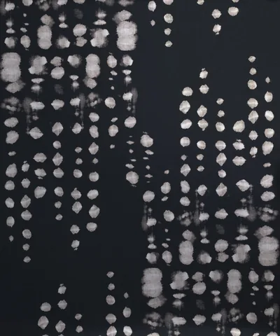 Strings of pale beads hang in loose columns against a dark navy ground, softened as if seen through glass.