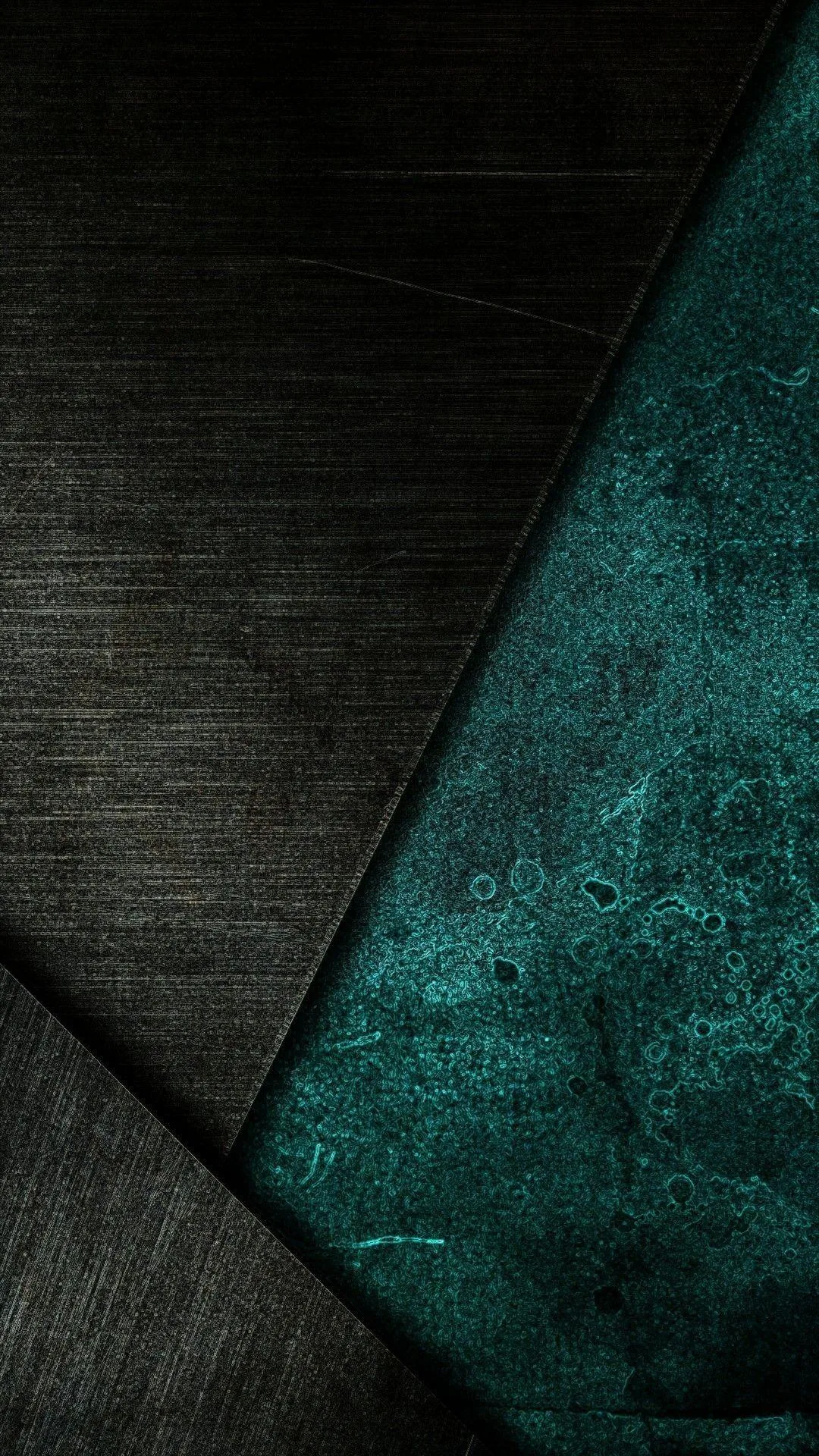 A weathered green-blue slab wedges between two slabs of brushed dark steel, its surface scratched and mottled like old oxidised copper.
