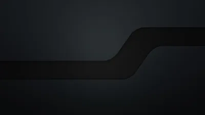 A wide glossy band crosses the middle of the frame and steps up to the right, its rounded corner catching the only real edge light here.