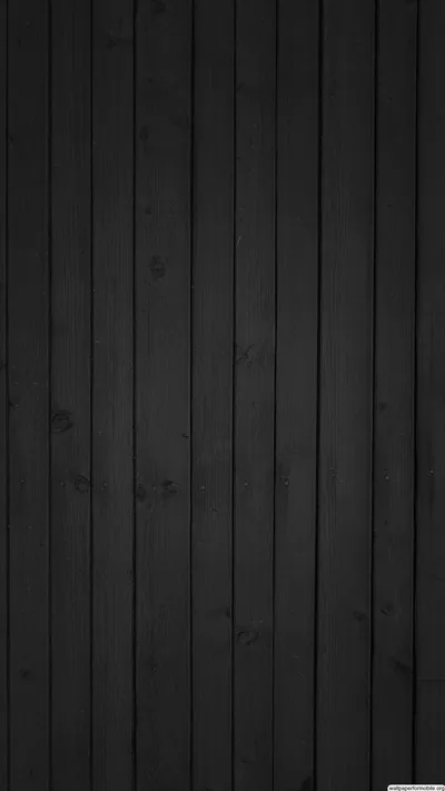 Narrow vertical boards run the full height of the frame, grain and knots just visible in the low side light.