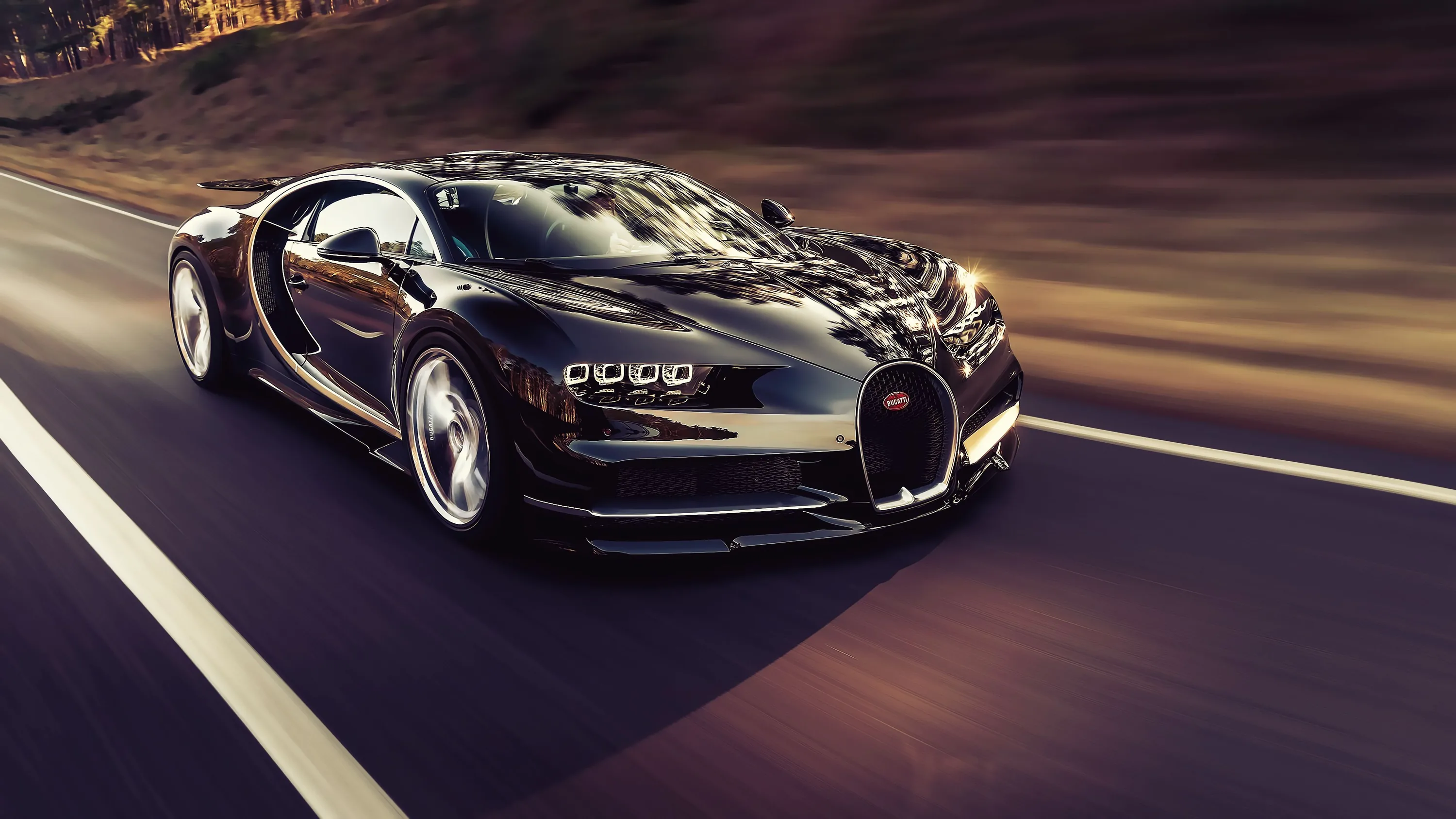 Panning shot of a black Bugatti tearing along a mountain highway, the guardrail and hillside smeared into streaks while the horseshoe grille stays razor sharp.