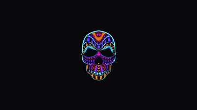 A skull filled with tribal patterns in blue, magenta and gold glows at the centre of a flat black background.
