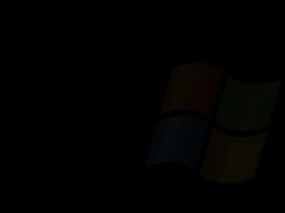The four-pane Windows flag sits right of centre, its red, green, blue and yellow dimmed almost to nothing against a completely black background.