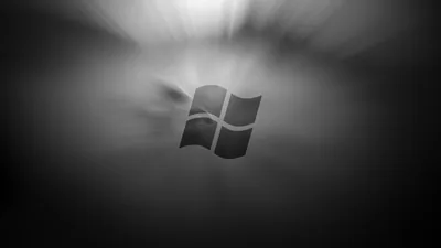 The window mark sits at the centre in soft focus, light radiating outward from behind it in a smoky grey haze.