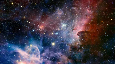 A crowded cluster of blue-white stars sits in the middle of rust and teal gas pillars, the darkest dust piling up along the right edge.