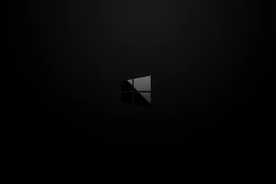 A small grey Windows mark sits alone in the middle of a soft black gradient, everything else left clear.