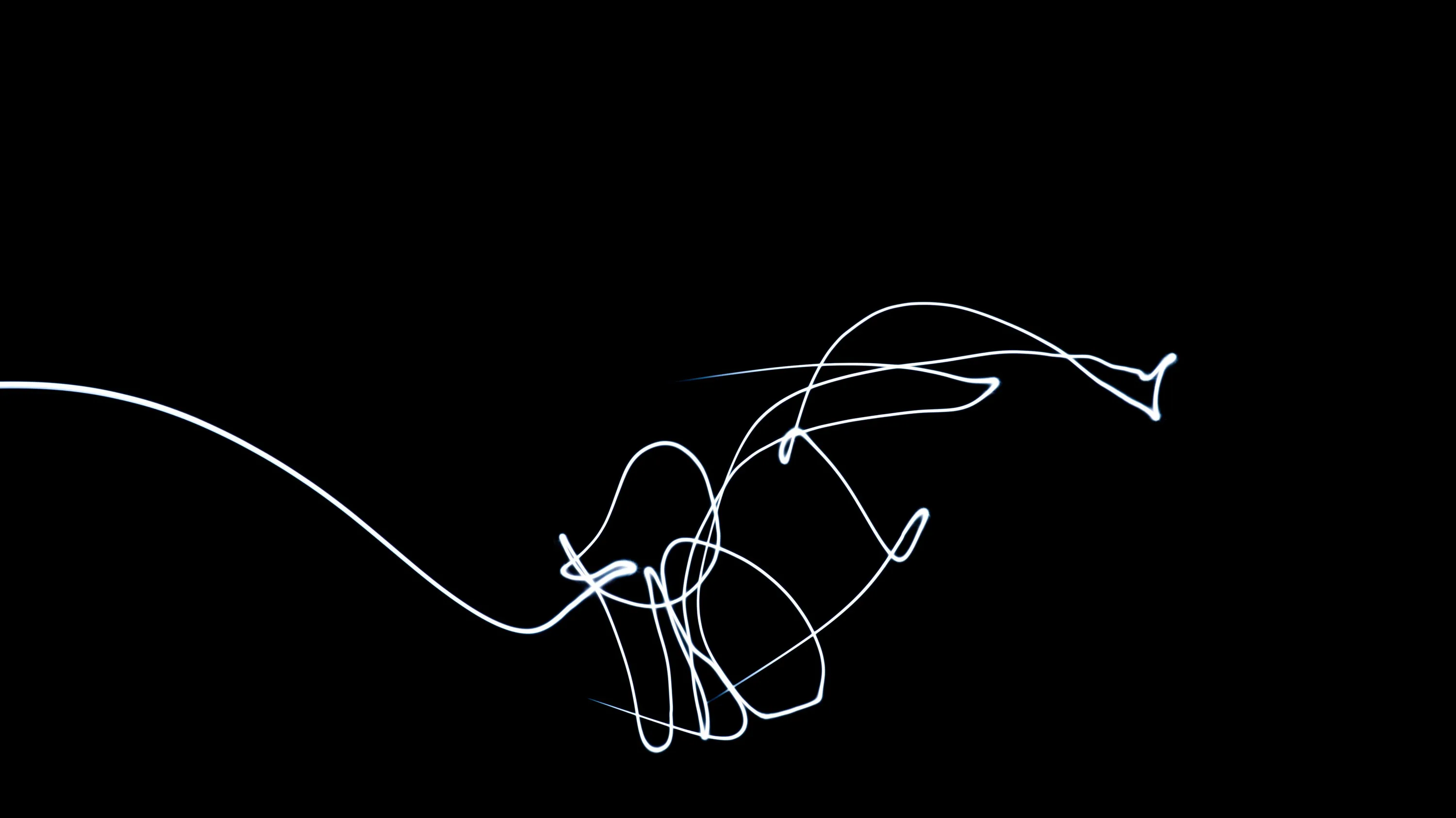 A single thread of white light loops and knots itself in the lower half of the frame, drawn with a long exposure.