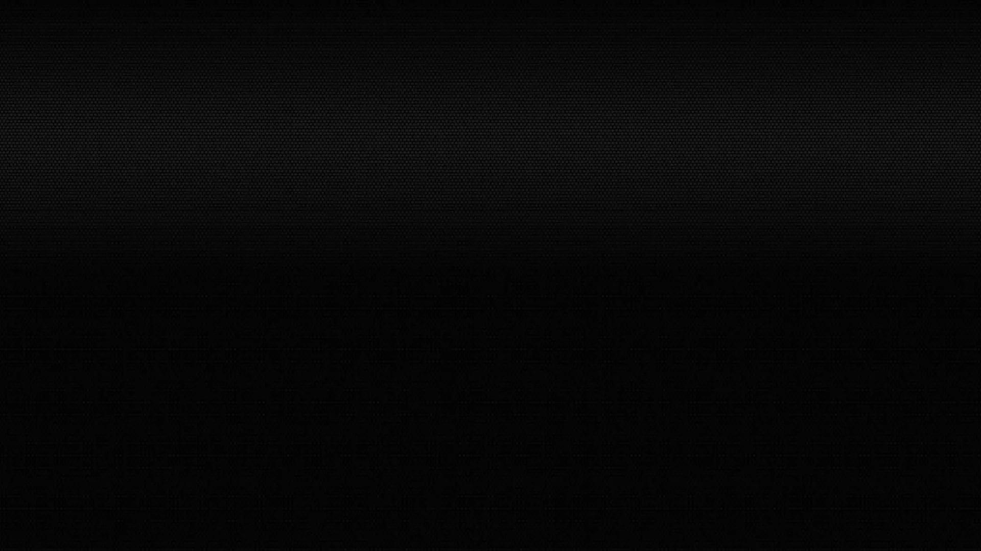Angular dark blocks sit low in the frame, only a shade above the black around them, with the upper half left completely clear.