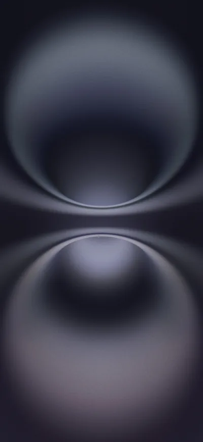 Two glossy grey-lilac spheres meet at the middle of the frame in mirror image, their soft blur fading to black at every side.