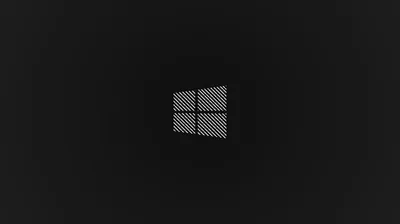 The Windows 10 square sits centred in a fine crosshatch texture on charcoal, the corners dropping to near black.