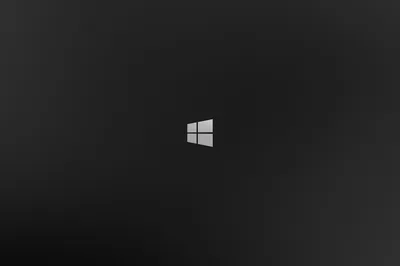 The white Windows 8 flag sits small and centred on a charcoal gradient that lightens slightly behind it, leaving the rest of the frame clear.