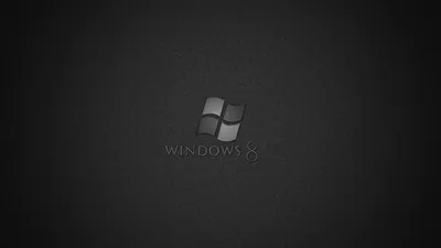 The four-pane Windows mark and its name sit embossed in grey at the centre of a grainy dark canvas, the corners pulled down by a heavy vignette.