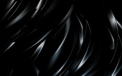 Sculpted black folds sweep diagonally across the frame, each ridge catching a thin highlight while the troughs between them stay in shadow.
