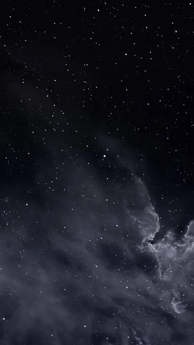 Thousands of stars scatter across a deep navy-black sky while a pale band of cloud drifts up from the lower right, leaving the top clear for icons.