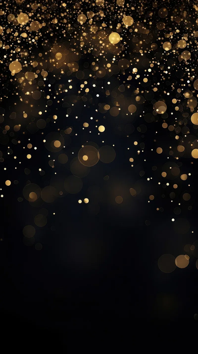 Gold particles fall through a black frame, sharp at the top and blurring into bokeh below.