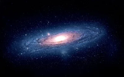 The Andromeda galaxy tilted across a plain black sky, its bright core left of centre so the right side stays free for desktop icons.