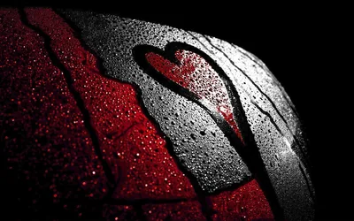 A heart shape cleared through condensation on dark glass, red light bleeding in from the left while the right side stays cold grey.