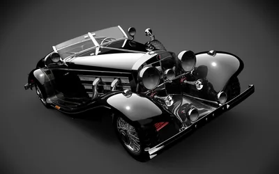 A prewar open roadster rendered from high above its tail, chrome exhaust pipes and big round headlamps gleaming against a smooth dark grey backdrop that fills every corner.