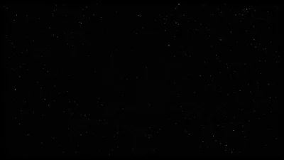Scattered pinpoint stars over an almost entirely black sky, thick enough near the top to read as haze and empty through the lower middle.