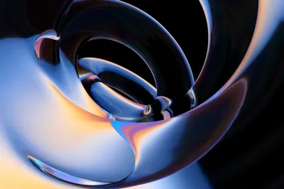 Smooth 3D petals nest inside one another, cool blue light along the outer edge and a warm amber glow pooling at the lower left.