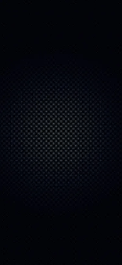Almost the whole frame is black, with a soft blue-grey glow surfacing at the centre and a fine dot screen visible only inside that light.