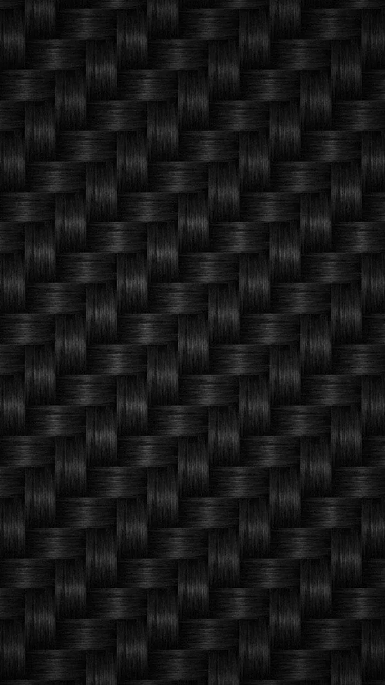 A tight basket weave of black fibres fills the frame, side lighting picking out the raised strands and dropping the gaps to near black.