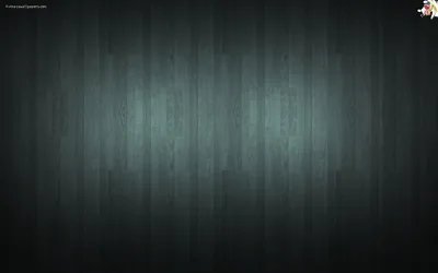 Narrow vertical planks run the height of a dark wall with a cold blue-green cast, a soft light pooling in the middle and the corners left almost black.