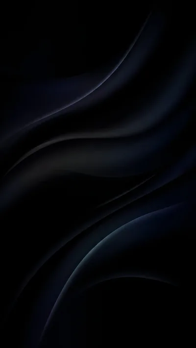Heavy folds of near-black silk run diagonally, a cold blue sheen picking out two ridges near the lower right corner.