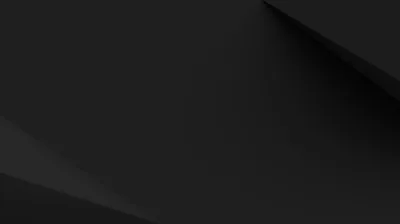 Broad charcoal planes fold across each other at shallow angles, the only shift in tone where one edge lifts into the light.