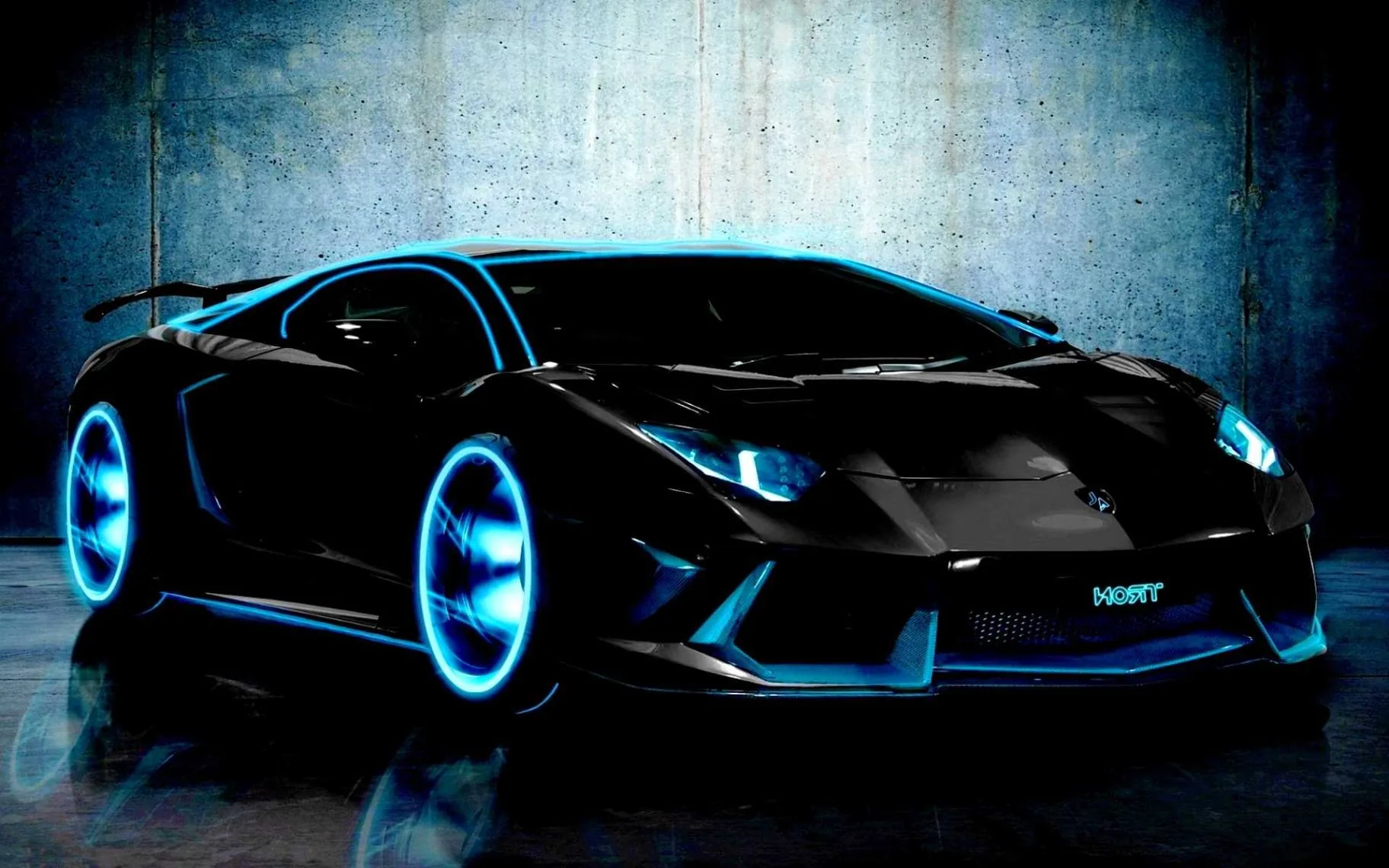Cyan light rings run through the wheels and body creases of a black Aventador shot against a scuffed concrete wall.
