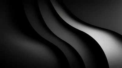 Two smooth waves cross the frame, one edge lit bright white and the other dropping straight into black.