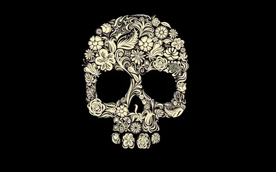 Vines, leaves and small blossoms are arranged into the shape of a skull in pale cream ink, the hollows left as empty black.