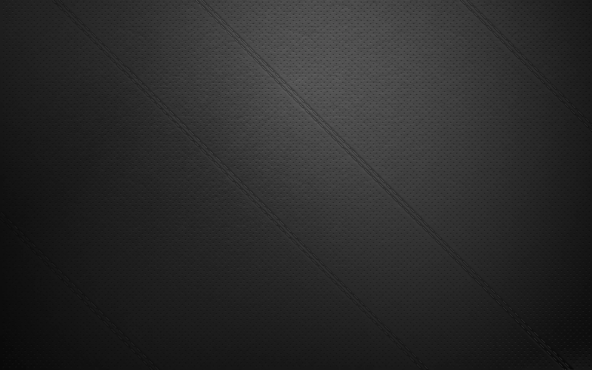 An even weave of dark grey cloth with one barely visible diagonal seam crossing the upper right, the tone lifting slightly towards the top.