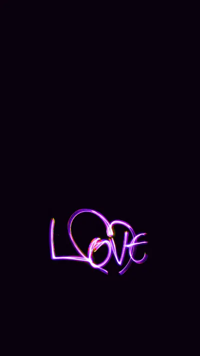 The word Love written in glowing violet neon script, placed low on a near-black field with a soft haze around the strokes.