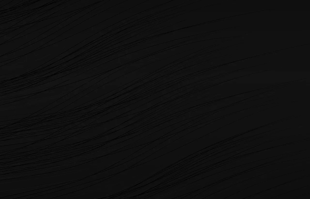 An almost flat black surface with faint diagonal grain lines running through the middle of the frame.