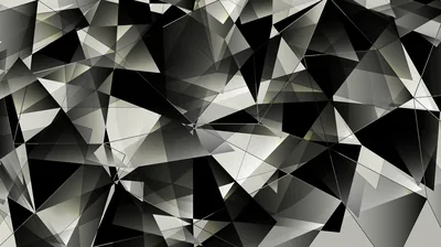 Broken triangular planes overlap edge to edge in black, grey and white, giving the whole surface a cracked glass look.