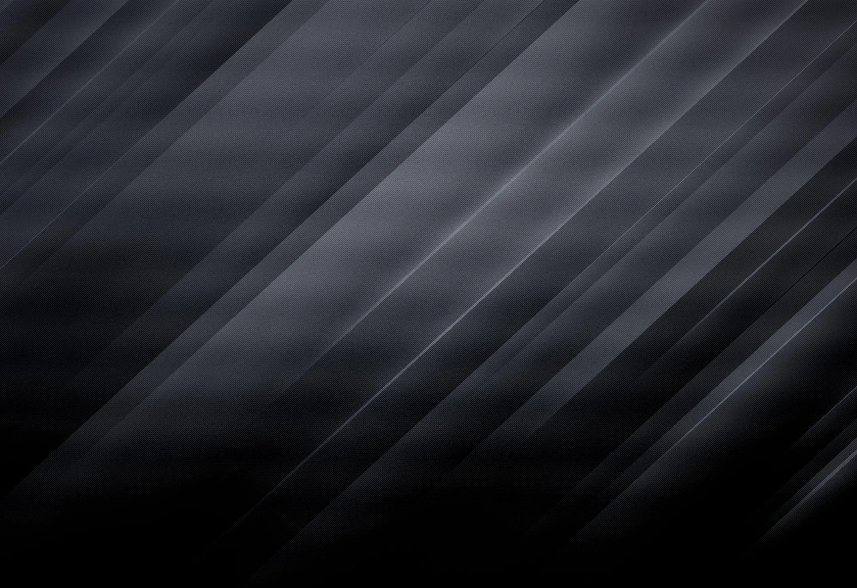 Bands of grey run corner to corner across black like brushed metal, catching more light toward the upper right.