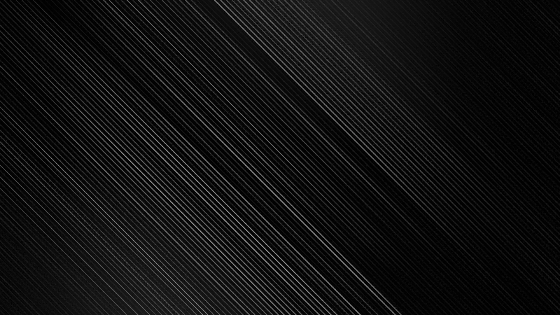 Fine diagonal lines run corner to corner across a dark surface, brightest through the middle band and fading out either side.