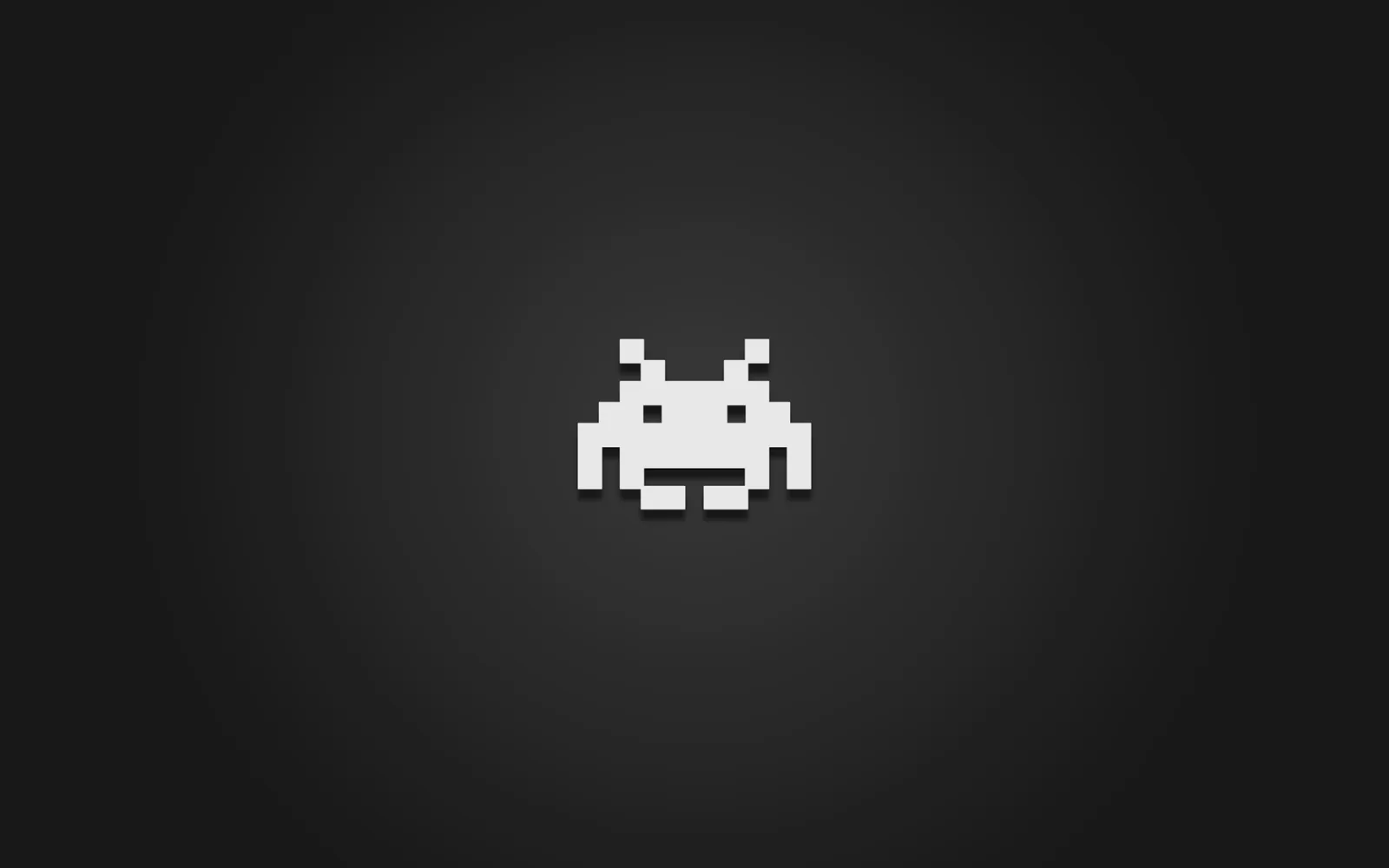 A single white pixel-art invader sits dead centre on a soft grey vignette, the corners fading to almost black.