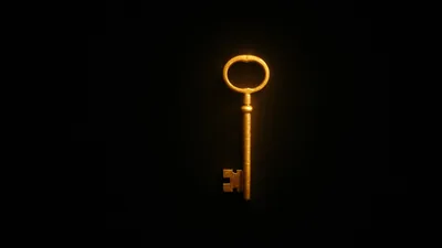 A single ornate key floats in the middle of an otherwise empty black frame, its warm gold outline throwing a soft halo into the dark.