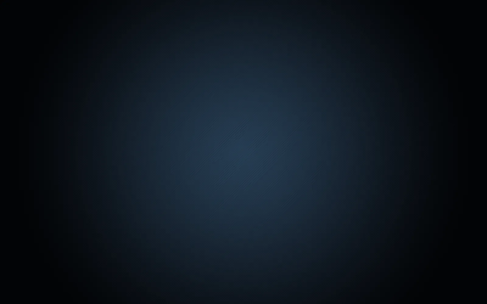A soft blue bloom sits just above the centre of a very dark navy field, dropping away to near-black at all four corners.