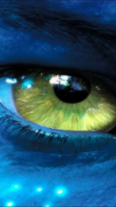 A yellow-green iris fills the middle of the frame, blue skin speckled with faint glowing dots around it; the darkest area sits along the bottom edge.