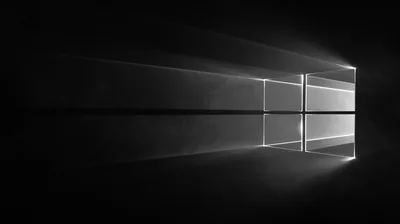 The Windows window rendered as a pane of light in a dark room, casting long beams across the floor.