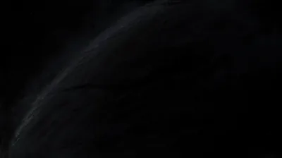 A faint curved ridge catches a trace of light across the lower half, everything above it dropping into near-total darkness.